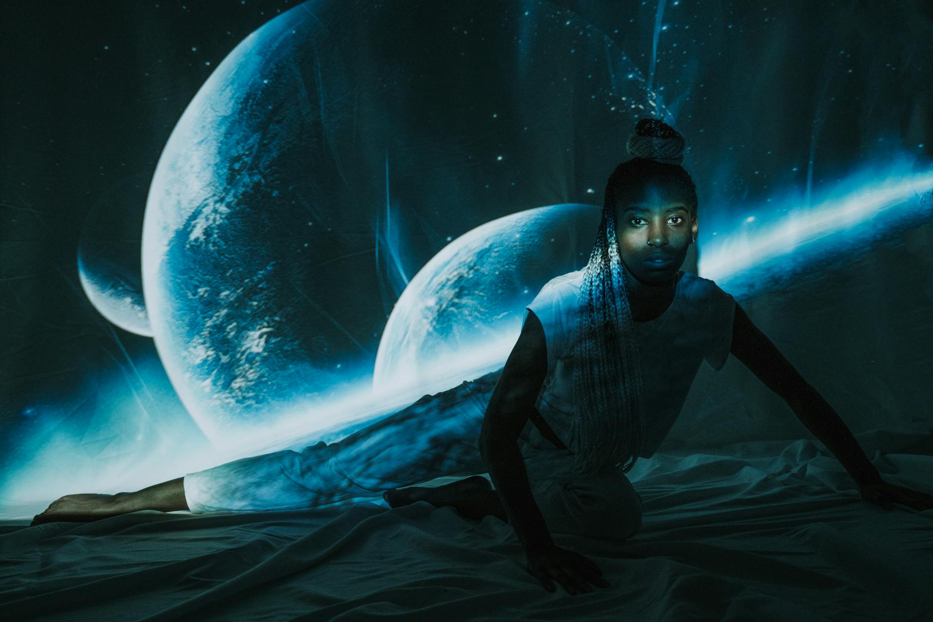 a woman posing in front of planetary image