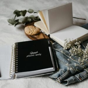 black notebook on white textile