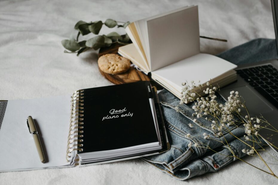 black notebook on white textile