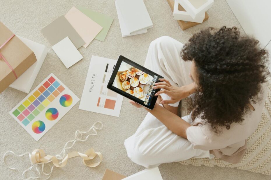 woman in white shirt holding black tablet computer