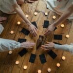 people holding black and brown cards